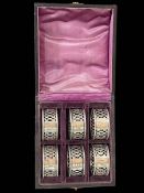 Cased set of six silver napkin rings.