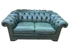 Bottle green buttoned leather two seater Chesterfield settee.