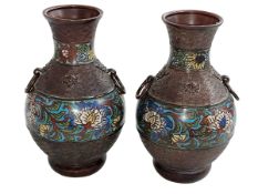 Pair of bronze vases each decorated with floral bands, circular ring handles, 24.5cm.