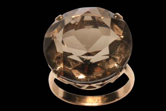 Large brilliant cut smokey quartz ring in claw set 14 carat gold, size K.