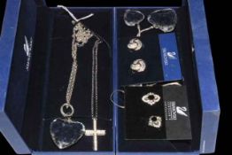 Three Swarovski necklaces and two pairs of Swarovski earrings.