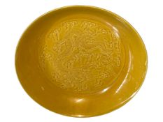 Chinese yellow glaze dish with impressed dragon design, six character mark to base, 19cm diameter.