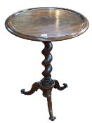 Circular mahogany occasional table on twist pedestal triform base, 74cm by 55cm diameter.