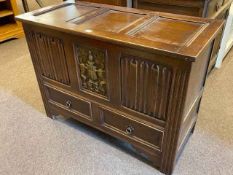 Oak linen fold panel blanket chest with two base drawers, 72cm by 99cm by 45cm.