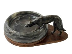 Antique model of bronze fox on hardstone dish.