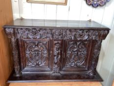 Antique carved oak wall cabinet having two carved drawers above two carved cupboard doors,