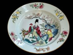 Chinese plate decorated with figures in landscape and floral border, 22cm diameter.