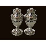 Two silver pedestal pepperettes, London 1790 and matching one, Birmingham 1932.