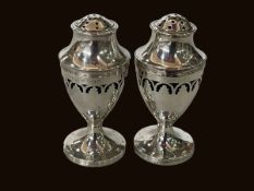 Two silver pedestal pepperettes, London 1790 and matching one, Birmingham 1932.