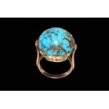 Large circular turquoise stone ring in gold setting (marks worn), size O.