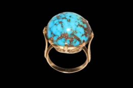 Large circular turquoise stone ring in gold setting (marks worn), size O.