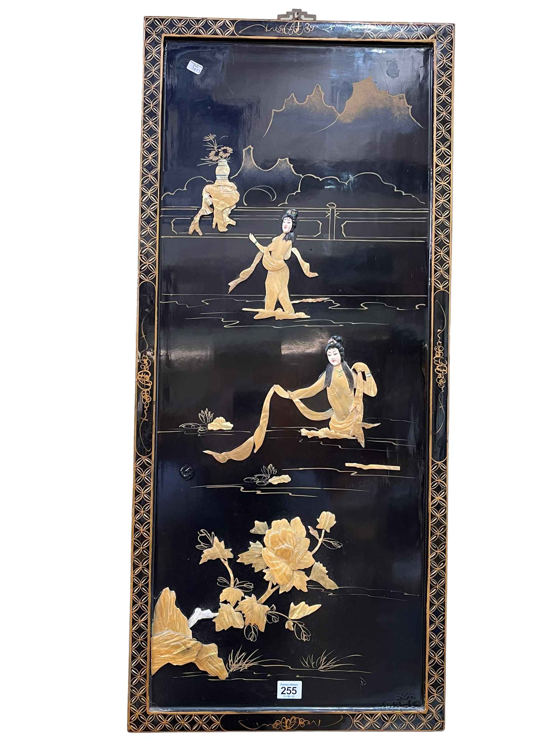 Two Oriental black lacquered panels with applied figure decoration, largest 92cm by 40.5cm.
