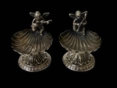Pair of musical figural shell silver salts.