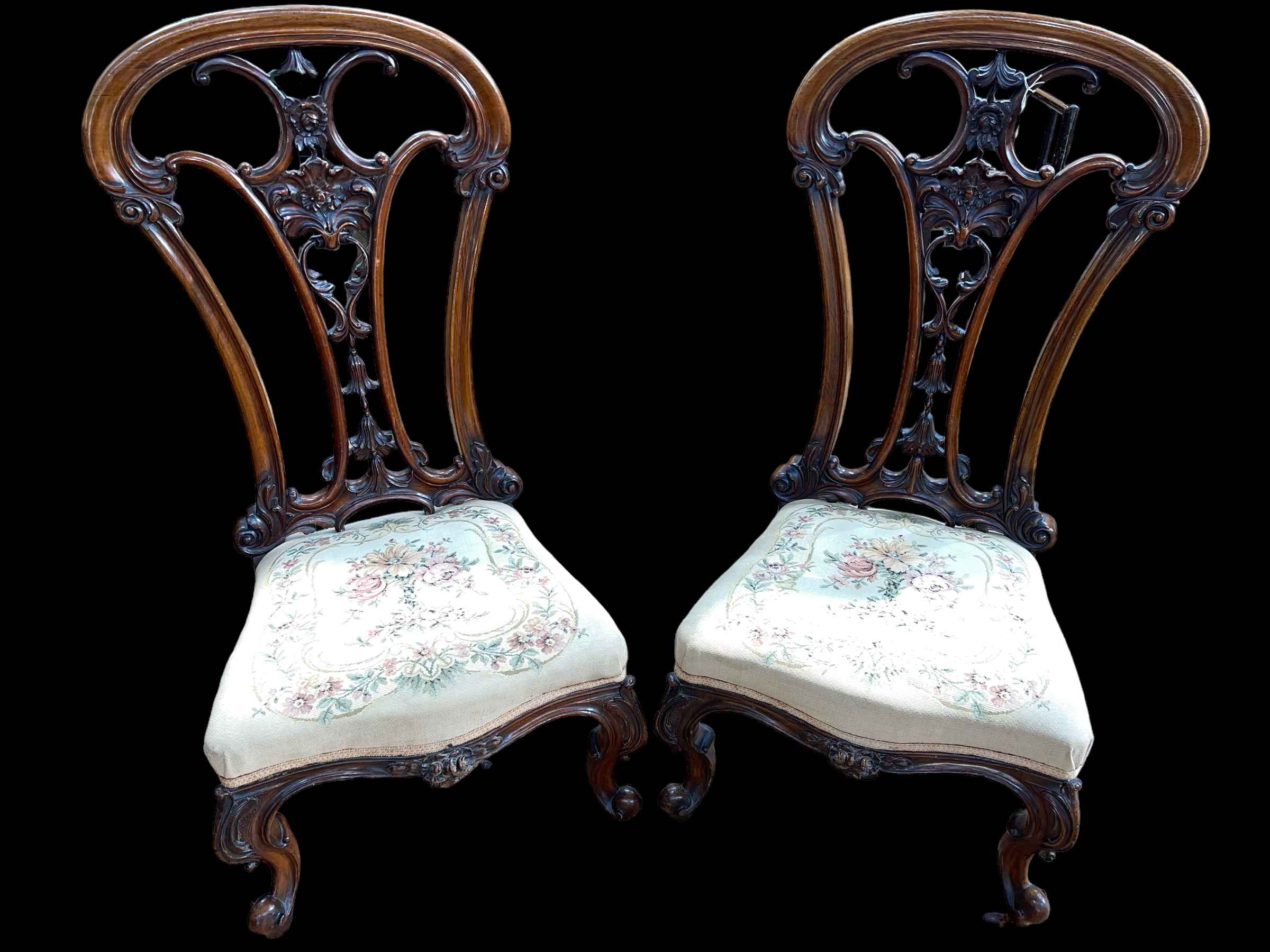 Pair Victorian mahogany open spoon back nursing chairs with floral tapestry seats.