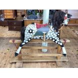 Sponge painted rocking horse on safety stand, 120cm by 137cm.