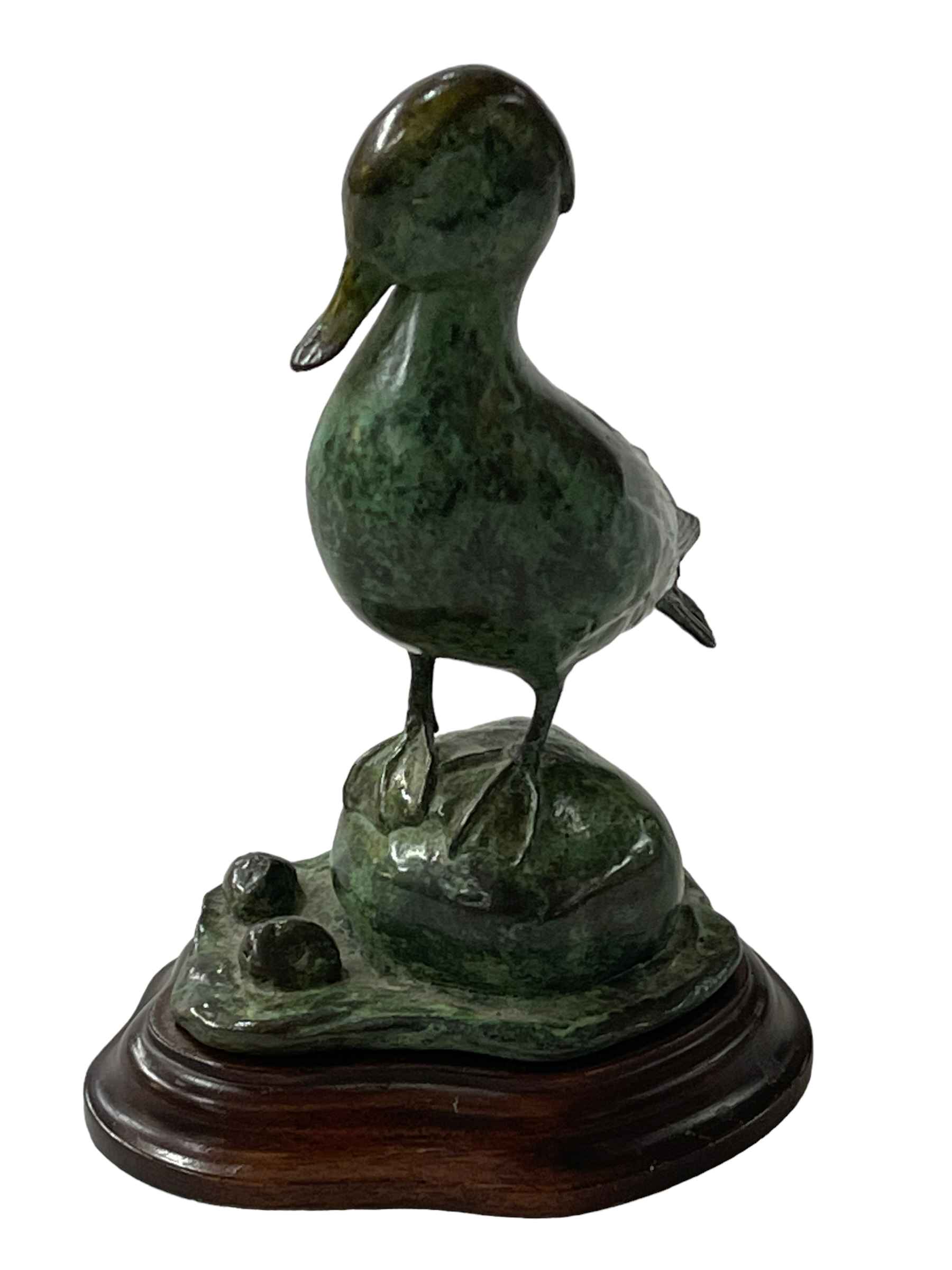 Green patinated bronze model of a duck on wooden stand, 13cm high. - Image 2 of 2