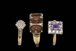 Three 9 carat gold rings, smokey quartz and diamond, diamond cluster and amethyst ring.