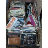 Box of single records including The Beatles.