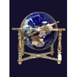 Brass mounted terrestrial globe inlaid with semi-precious gemstones, approximately 40cm high.
