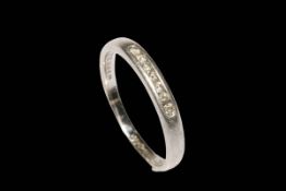 Platinum and diamond seven stone band ring, size O.