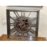 Wall mounted clock with moving cogs, 61cm by 61cm.