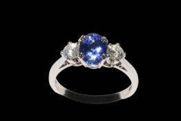 18 carat white gold tanzanite and diamond three stone ring, the tanzanite approximately 1.