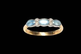 Three stone aquamarine and four stone diamond ring in yellow gold (marks worn),