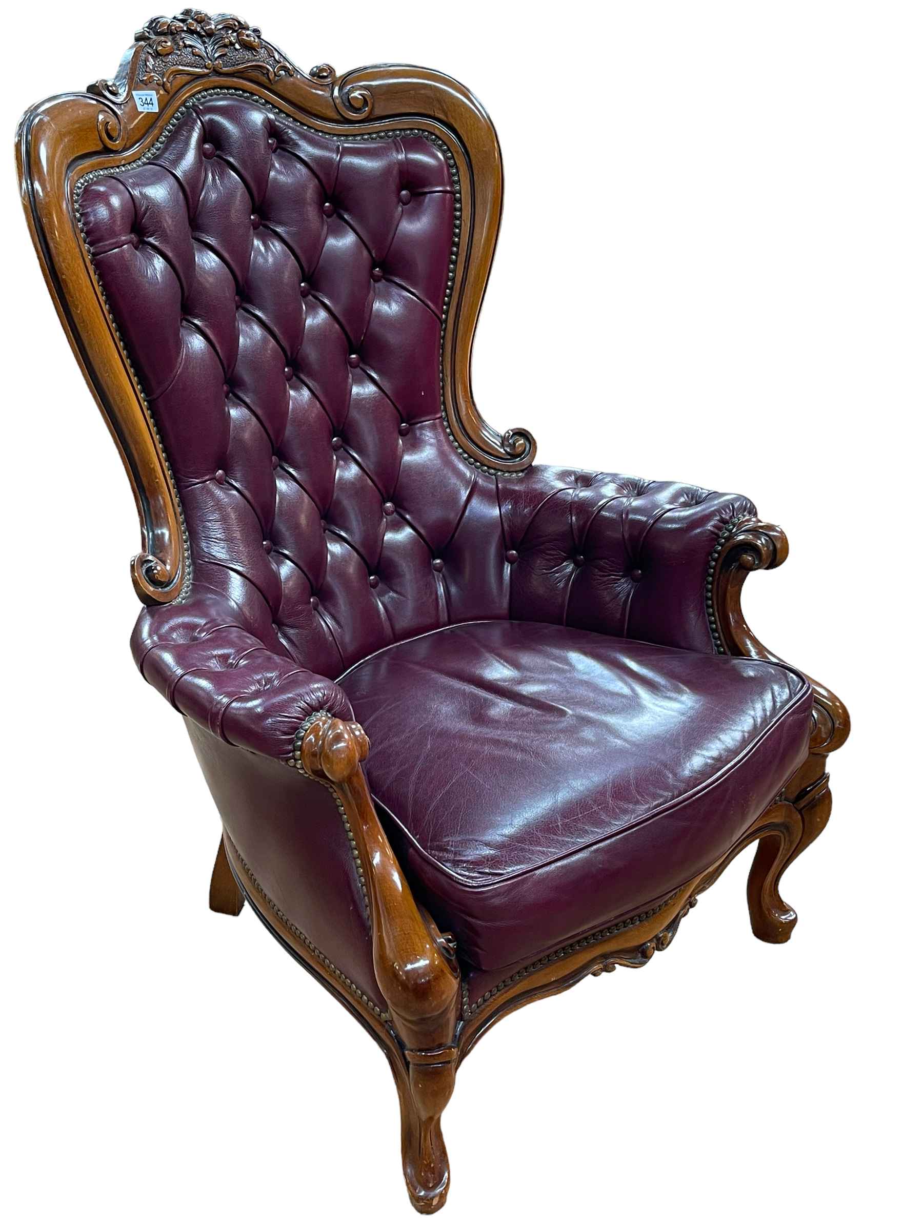 Victorian style burgundy buttoned leather armchair.