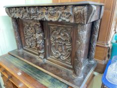 Antique carved oak wall cabinet having two carved drawers above two carved cupboard doors,