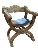 X-framed Armorial carved back armchair with leather seat.