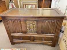 Oak linen fold panel blanket chest with two base drawers, 72cm by 99cm by 45cm.