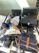 Collection of cameras and binoculars including Prinzlux, Frank Nipole, Pathescope, Canon EOS 5000,