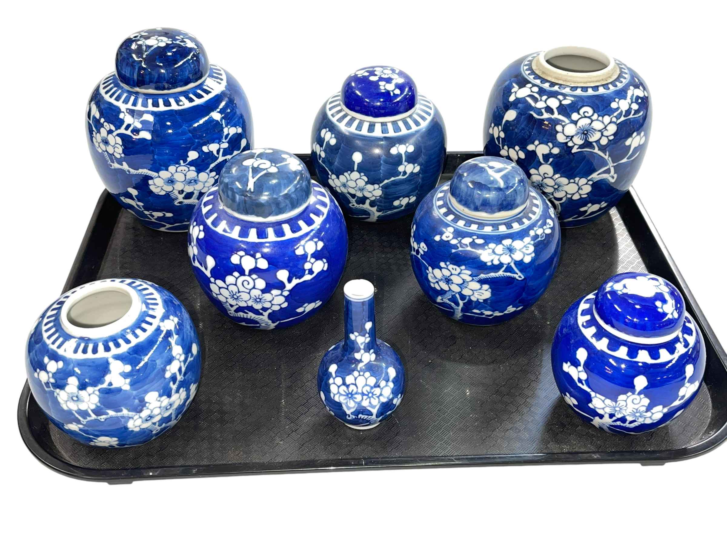 Small Chinese blue and white vase and seven ginger jars all decorated with prunus.