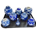 Small Chinese blue and white vase and seven ginger jars all decorated with prunus.