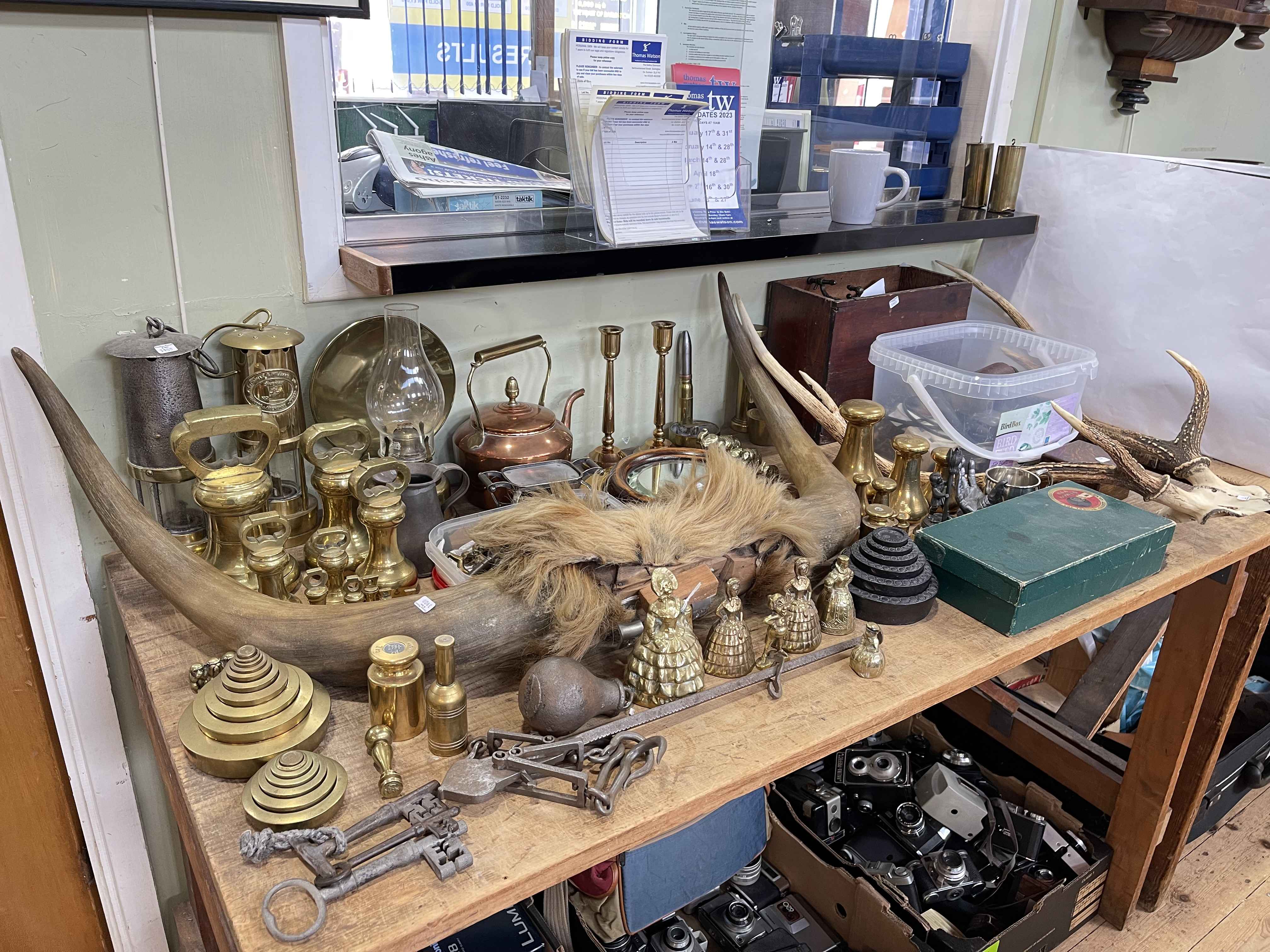 Collection of metalwares including miners lamps, bell weights, ship's mirror, trench art,