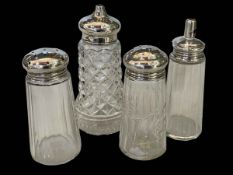 Four silver topped glass sugar casters.