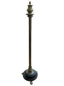 Brass reeded column standard lamp on three paw feet.