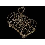 Early Victorian silver seven bar toast rack on scroll feet, London 1841, 16cm across.