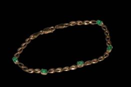 9 carat gold bracelet set with five oval emeralds.