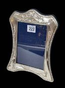 Silver easel photograph frame with embossed decoration, London modern, 23cm by 18cm.