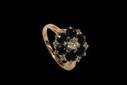 Sapphire and diamond 18 carat gold cluster ring, size J/K.