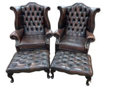 Pair brown deep buttoned and studded leather wing armchairs and footstools.