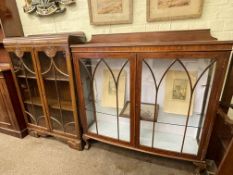 Mahogany two door china cabinet on ball and claw legs and two door oak bookcase.