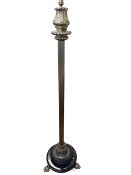 Brass reeded column standard lamp on three paw feet.