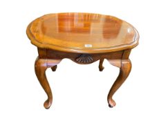 Polished oval shaped coffee table on cabriole legs, 55cm by 67cm by 57cm.