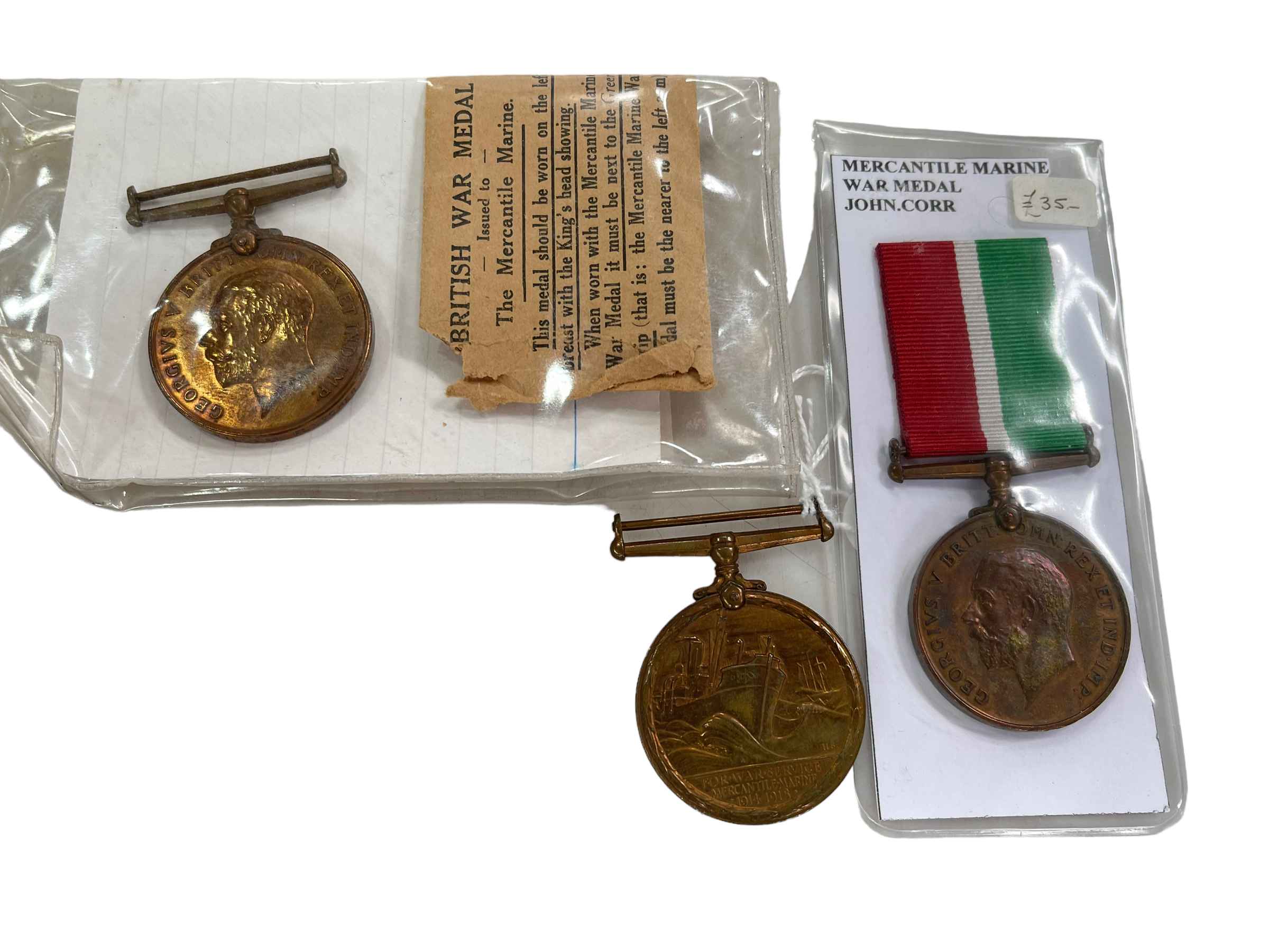 Three mercantile marine medals awarded to John Curr, Ivor M. Sanderson and William Fletcher.