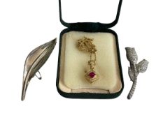 Ruby and diamond 18 carat gold pendant, Danish silver leaf brooch, and paster tulip brooch (3).