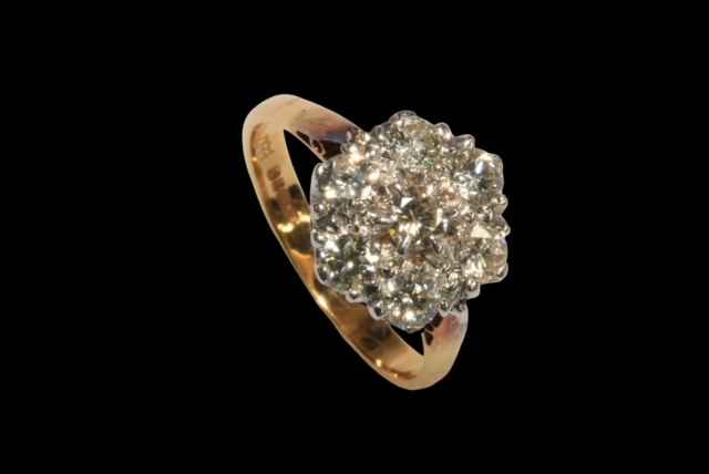 Seven stone diamond petal design ring, the diamonds claw set in white gold to yellow gold shank,