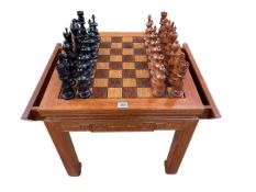 Oriental rosewood chess table having two slides and two storage drawers together with a carved wood