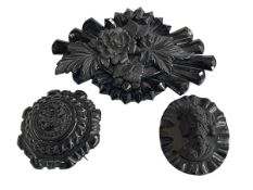 Two Whitby jet brooches and large replica brooch (3).
